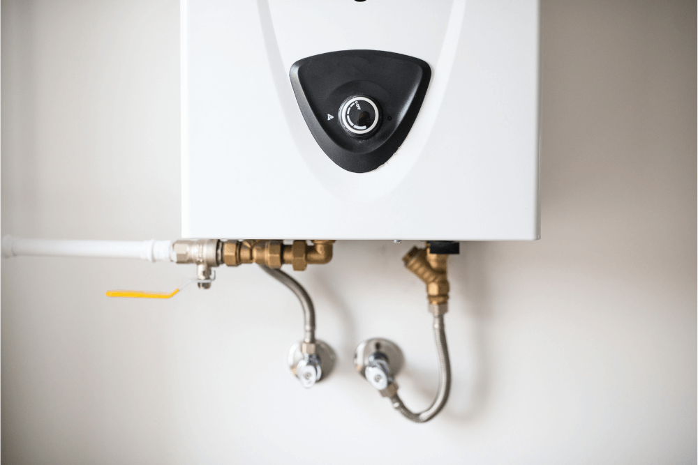 Qualified Dubai plumber performing a full water heater geyser service — draining sediment buildup caused by Dubai hard water and replacing the heating element for maximum efficiency
