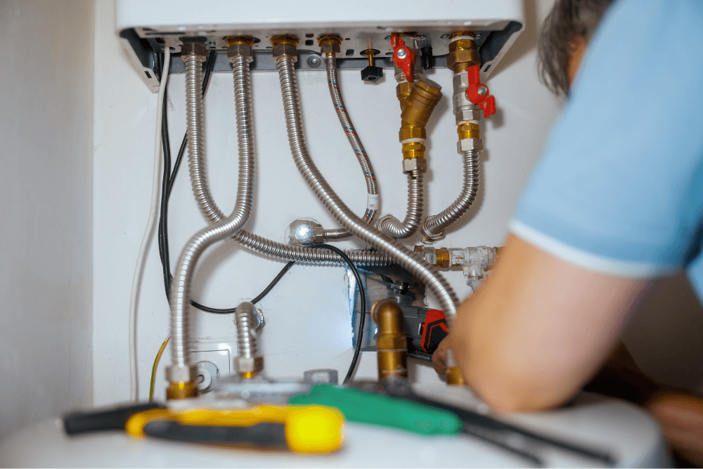 Licensed Dubai emergency plumber inspecting residential gas pipes and fittings for dangerous leaks using professional gas detection equipment in a Dubai villa