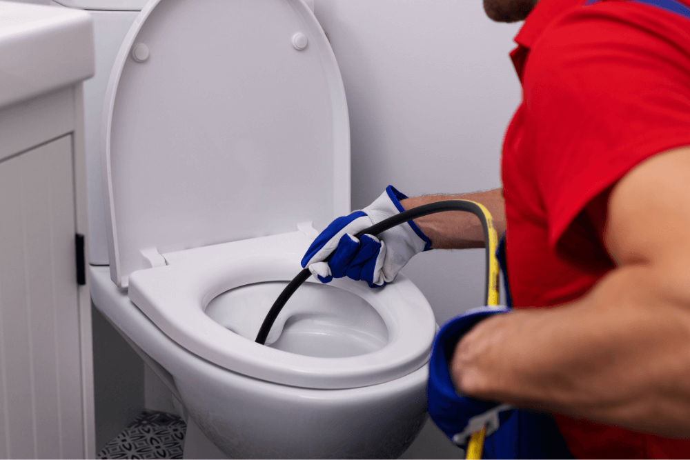 Emergency plumber Dubai unblocking a severely clogged toilet in a residential bathroom, providing fast 24/7 hygiene-first plumbing service for villas and apartments